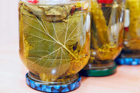 Glass jar with pickled cucumbers