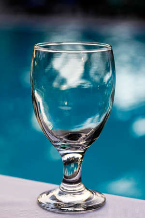Empty wine glass isolated on blue backgroundの写真素材