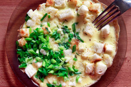 Scrambled eggs with bread and finely chopped green onionsの写真素材