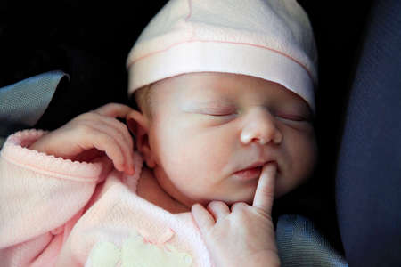 Sleeping newborn baby. The first days of life of the newborn girl