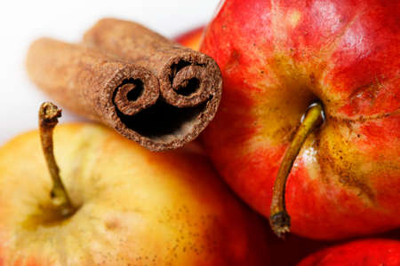Red apples and cinnamon close-up on a white backgroundの写真素材