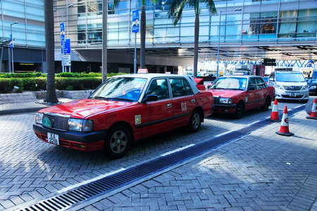 Hong Kong, Hong Kong S.A.R. - December 29, 2014: Red taxi in Hong Kong Airport. Most of the vehicles on Hong Kong's streets are taxis.のeditorial素材