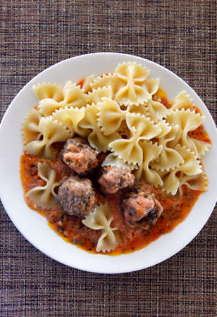 Small meat balls with pasta and red sauceの写真素材