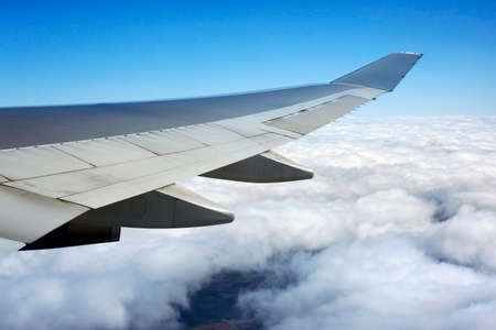 Wing of the plane on a background of cloudsの写真素材