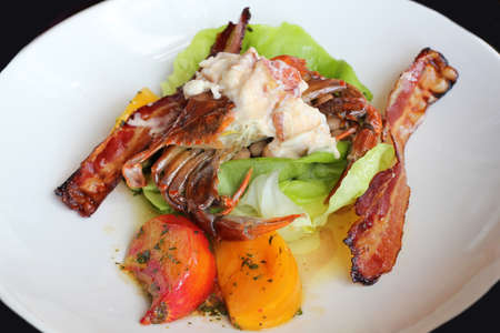 Appetizer of crab with vegetables and fried baconの写真素材