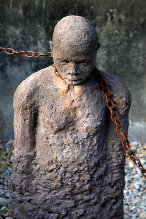 A statue in Stone Town, Zanzibar dipicting and mourning the African slave tradeの写真素材