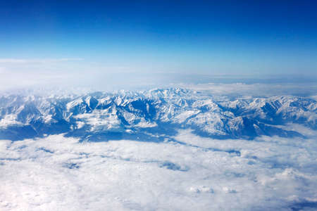 Winter mountains and white clouds top viewの写真素材
