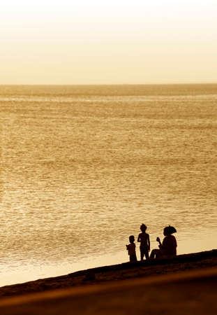 Stone Town, Zanzibar, Tanzania - January 2, 2016:  Family frolick in the surf in Stonetown, Zanzibar, Tanzania.のeditorial素材