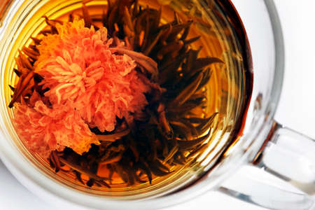 Cup with blooming tea close upの写真素材