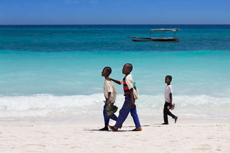 Zanzibar, Tanzania - January 6, 2016: Three unknown African boy walking on the beach in Zanzibarのeditorial素材