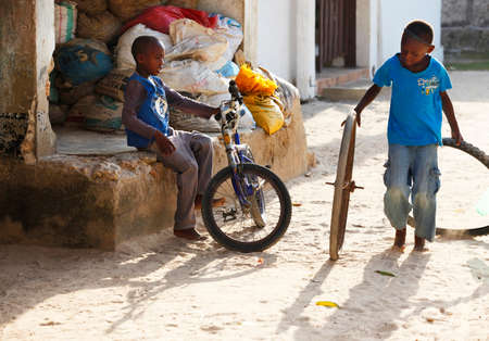 Zanzibar, Tanzania - January 8, 2016: two unknown African boy playing in the street in the village of Jambiani, Zanzibar. Tanzaniaのeditorial素材