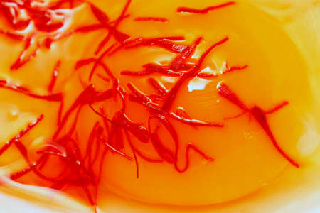Raw egg with saffron close-up