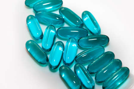 Blue capsules on white background close upの写真素材
