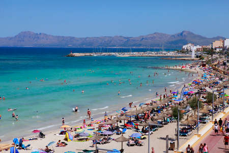 Mallorca, Spain - June 29, 2015: The tourists enjoiying their vacation on the beach. Up to 60 mln tourists is expected to visit Spain in year 2015.のeditorial素材