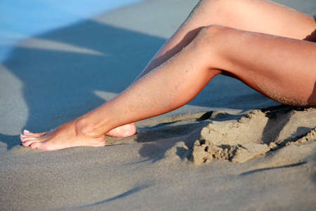 Female barefooted legs and sandの写真素材