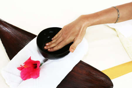 Hands of the masseur with a cup with aloeの写真素材