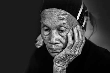 Hainan, China - April 7, 2012: Senior chanees woman with a worried expression face. China, Hainan - Li and Miao Villageのeditorial素材
