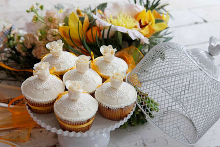 Beautiful cakes and bridal bouquet in orange tonesの写真素材