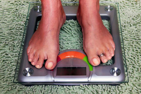 Bathroom scales isolated against green carpetの写真素材