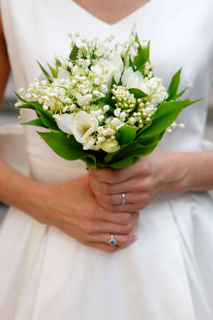 The bride holds a wedding bouquetの写真素材