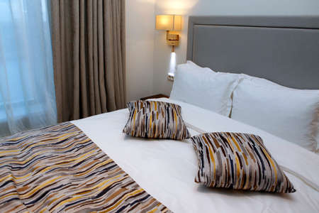 Nice bedroom with the big bed.の写真素材