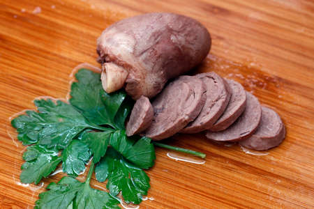 Roasted turkey heart with a leaf of parsley close upの写真素材