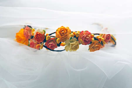 Wreath Bride of orange flowers on a background of a veilの写真素材