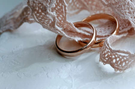 Wedding rings on a pink tape close-upの写真素材
