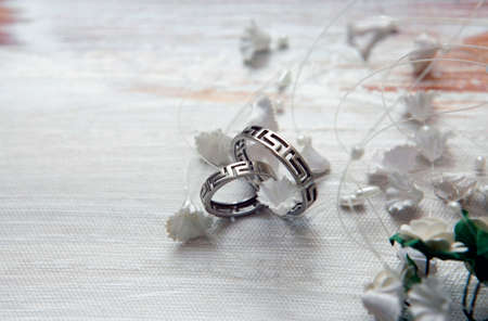 Wedding rings on a satiny fabricの写真素材