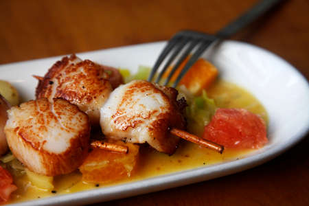 Close up Scallop seafood appetizer with with oranges and grapefruitsの写真素材