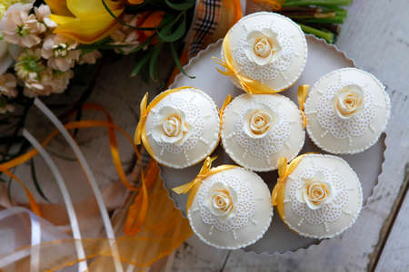 Beautiful cakes and bridal bouquet in orange tonesの写真素材
