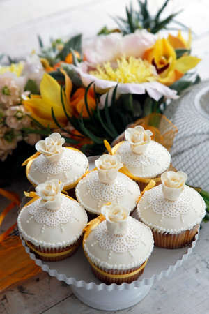 Beautiful cakes and bridal bouquet in orange tonesの写真素材