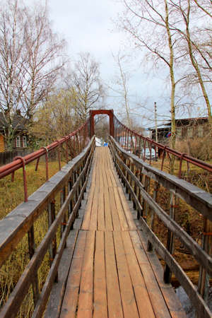 Suspension bridge across the Volga River in the village of Verkhovazhye Vologda region. Russiaの写真素材