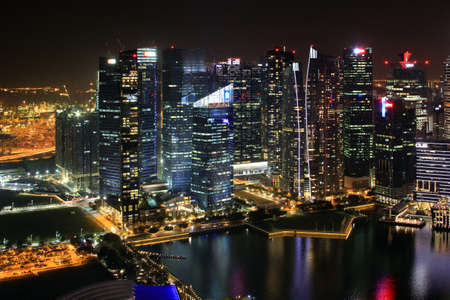 Singapore, Singapore - October 2, 2016: Night view of the Marina Bay skyline from the Marina of Singapore at night . People are on the promenade that is full of restaurant and shops.のeditorial素材