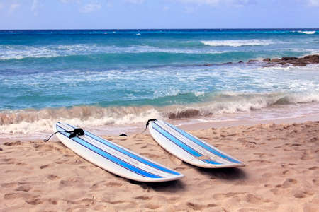 Surfboards at Dover beach on island Barbados on sandy shore by oceanの写真素材