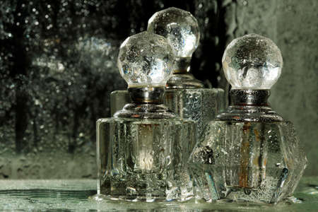 Bottles for perfumery with patches of lightの写真素材
