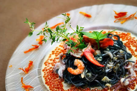 Black pasta with lobster cream sauce and caviarの写真素材