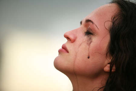 Portrait of a young crying brunetteの写真素材