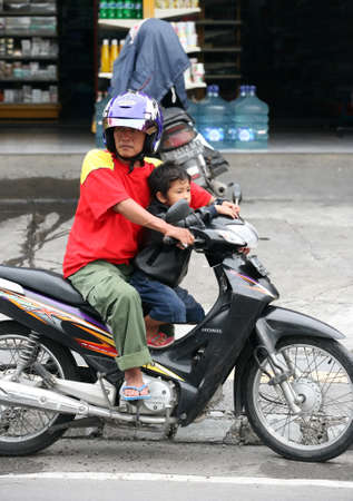 Father with the small child on a motorcycle. Bali. Kutaのeditorial素材