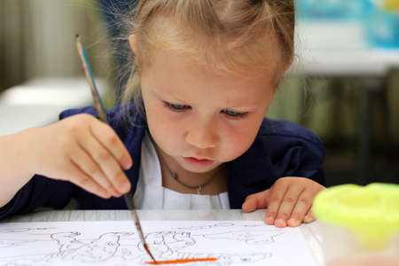 Cute little girl painting watercolorsの写真素材