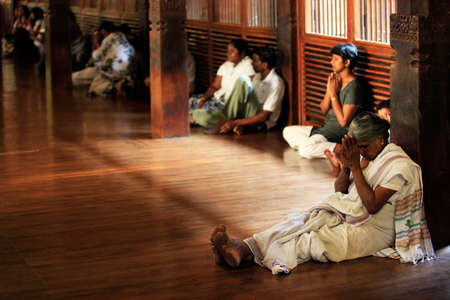 Kandy, Sri Lanka - April 03, 2011: People pray in Buddhist church. Kandy, Sri Lankaのeditorial素材