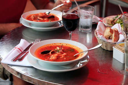 Bowl of spicy fish soup with tomatoes and musselsの写真素材