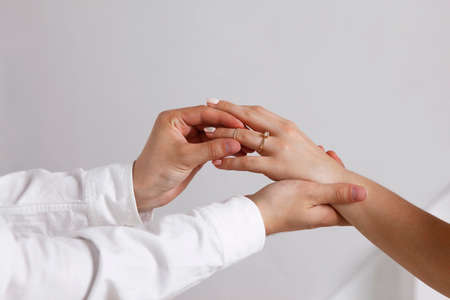 Bride wears a wedding ring to the groomの写真素材