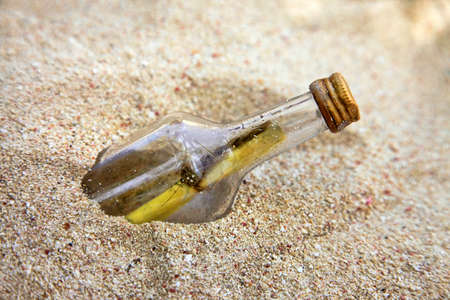 Message in the bottle on sand beachの写真素材