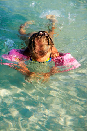 Little girl dives in the clear seaの写真素材