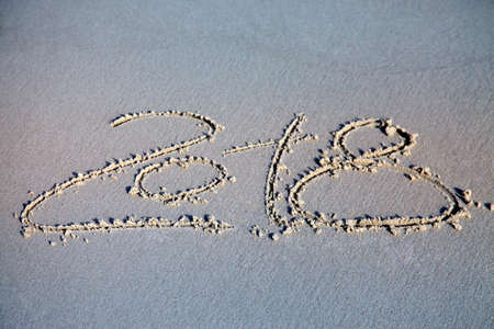 New year 2018 written on sand