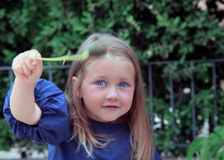 Little girl laughing in the background of parkの写真素材