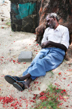 Pereber, Mauritius - January 23, 2012 : A homeless man sleeps on the sidewalk in city Pereber on Mauritiusのeditorial素材