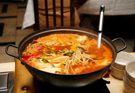 Delightful healthy Asian kitchen - magnificent and nutritious Korean soup with noodles and seafoodsの写真素材