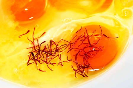 Raw egg with saffron close-upの写真素材
